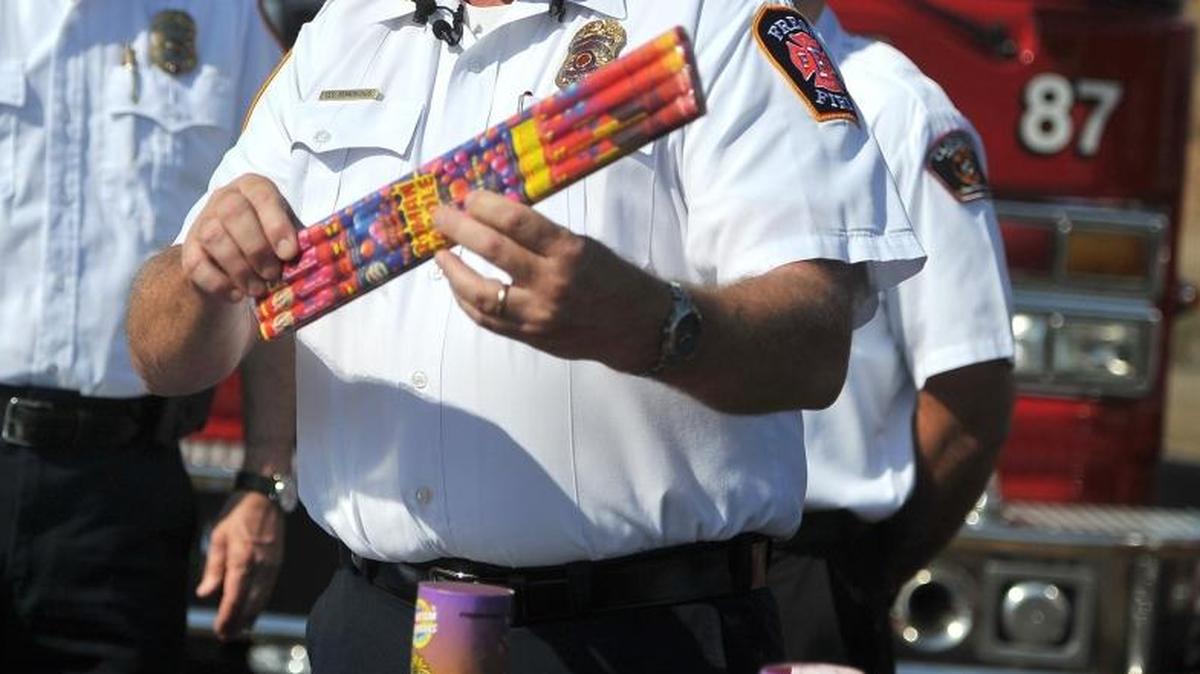A fire official shows a package of Roman candles, a type of bottle rocket that is illegal, in an undated file photo.