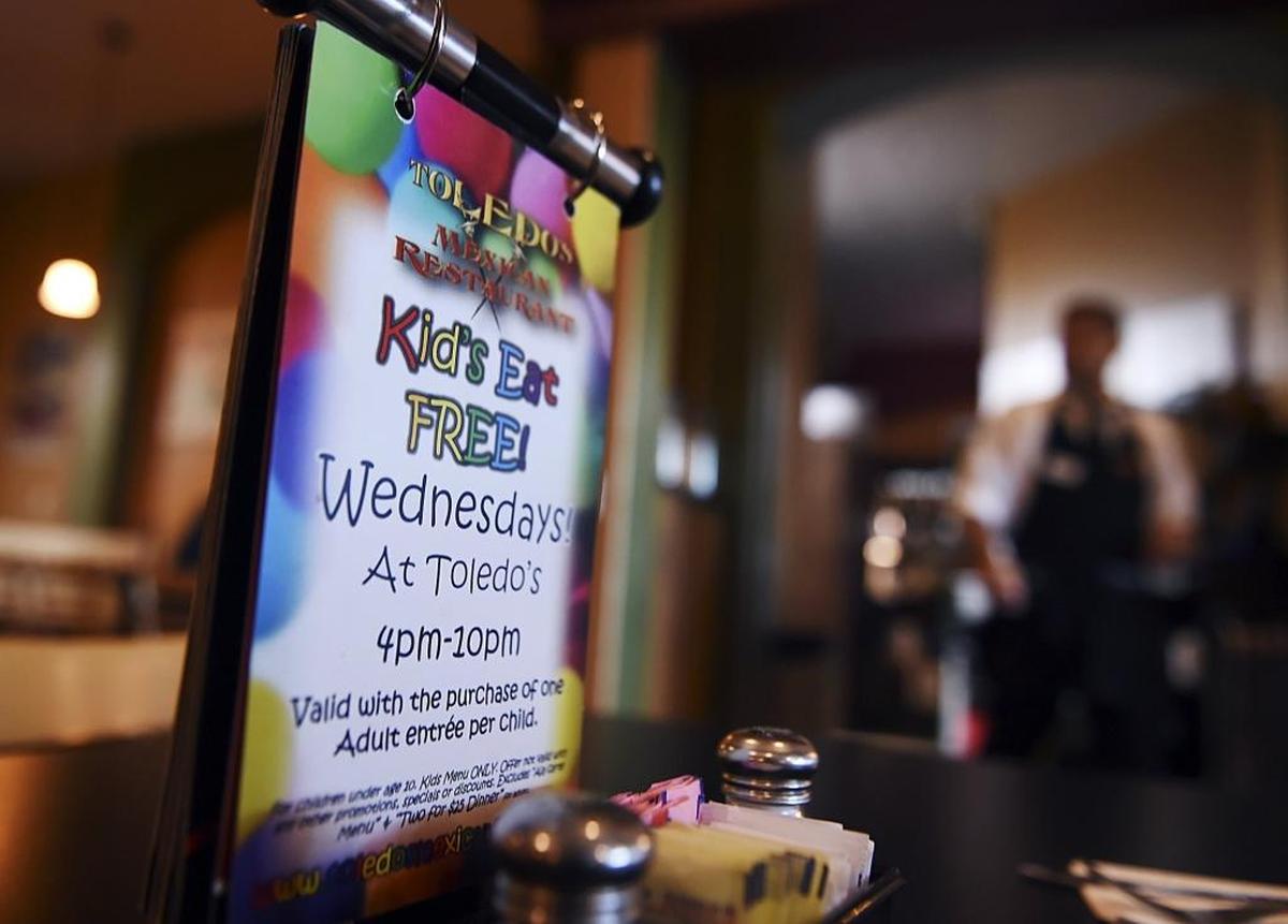 One of many signs around the restaurant promoting the special kids-eat-free night on Wednesdays at Toledo’s Mexican Restaurant, Oct. 25, 2017 in Fresno. The Toledo family would traditionally gather for dinner together on Wednesdays, and in 2013 they began a new tradition of offering free kids dinners on Wednesdays to help families make ends meet.