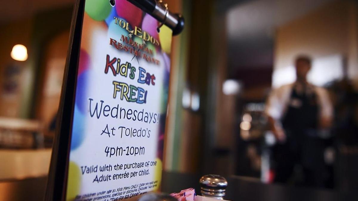One of many signs around the restaurant promoting the special kids-eat-free night on Wednesdays at Toledo’s Mexican Restaurant, Oct. 25, 2017 in Fresno. The Toledo family would traditionally gather for dinner together on Wednesdays, and in 2013 they began a new tradition of offering free kids dinners on Wednesdays to help families make ends meet.