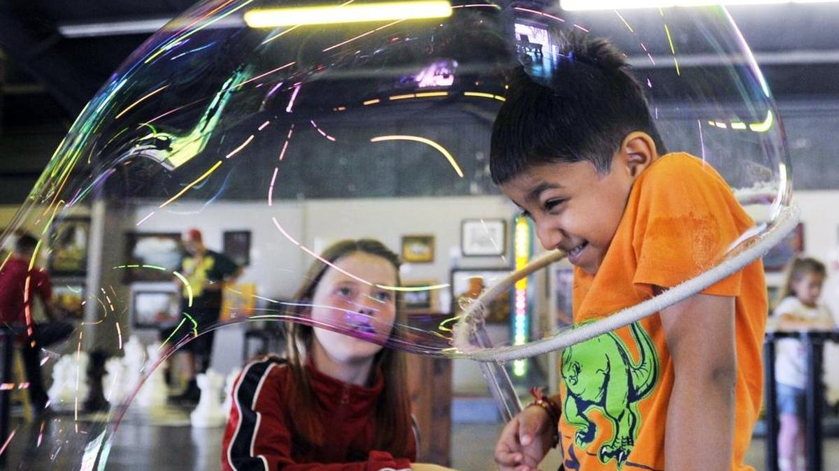 
Shaniya Schaible, 12, left, draws a large bubble over Shivang Bhavan, 4, at the Kids Zone on Thursday, the second day of the Tulare County Fair in Tulare. The annual fair concludes Sunday.
