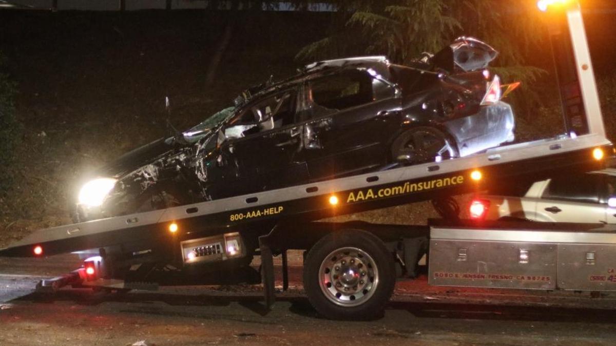 A car believed to have been damaged in one of a series of accidents along Highway 99, apparently triggered by slippery conditions when a truck spilled part of its load of olives, awaits to be towed away near the McKinley Avenue on-ramp Thursday, Nov. 23, 2017.