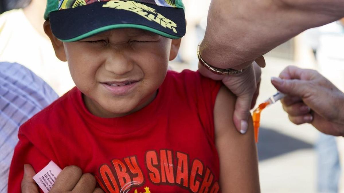 Adrian Alexander Gaonzalez, 5, braces himself as he gets a flu shot during a vaccination clinic sponsored by the Stanislaus County Health Services Agency at the El Rematito Crows Landing Flea Market in Modesto in 2014.