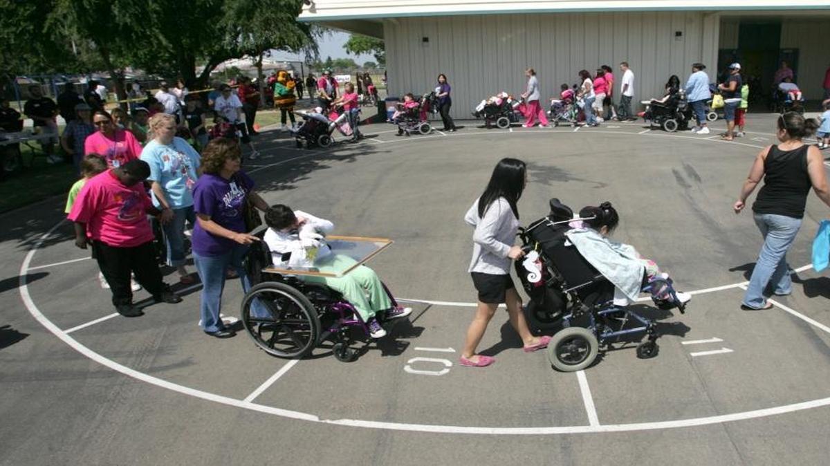 Students are pushed in their wheelchairs during an event at Addicott Elementary in 2012. The school serves students with severe disabilities.