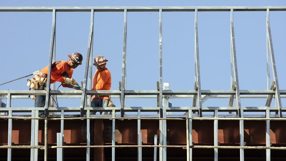 Harris Construction workers put beams into place on the roof of one of two classroom buildings at Fresno High School in this 2012 photo. Contracts given by Fresno Unified to Harris have come under scrutiny in a federal investigation.