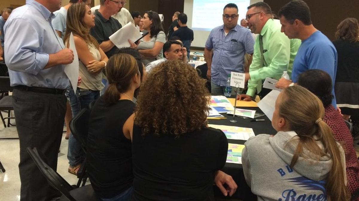 
Bud Rank Elementary School Principal Ryan Gettman (in the green shirt) answers parents’ questions about new attendance boundaries at a meeting at Clovis North High School on Monday night, Sept. 21.
