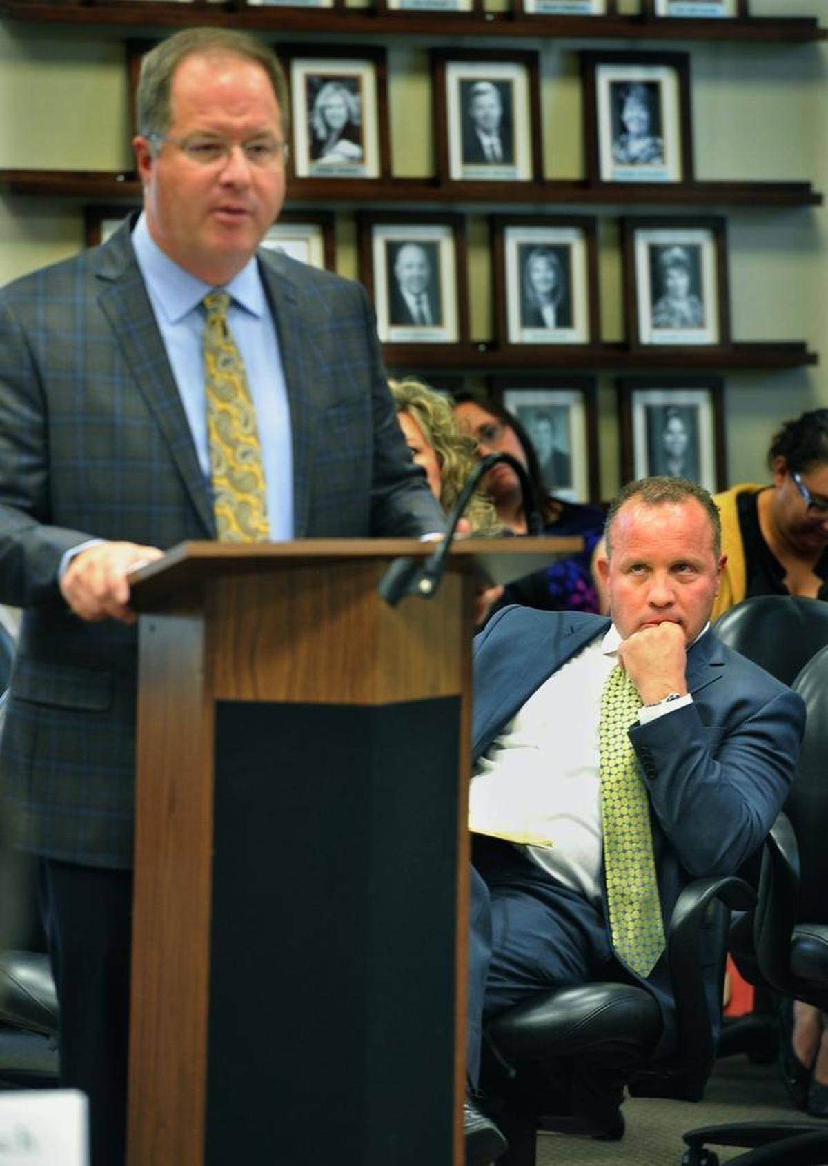 Former Fresno Unified school board President Brooke Ashjian, sitting, watches former Superintendent Michael Hanson debate him at a Chamber of Commerce meeting in September 2016.