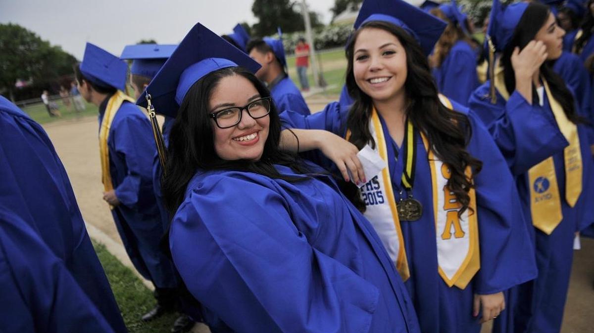 Friends pose before the start of Parlier High School’s graduation ceremony June 9, 2015 in Parlier.