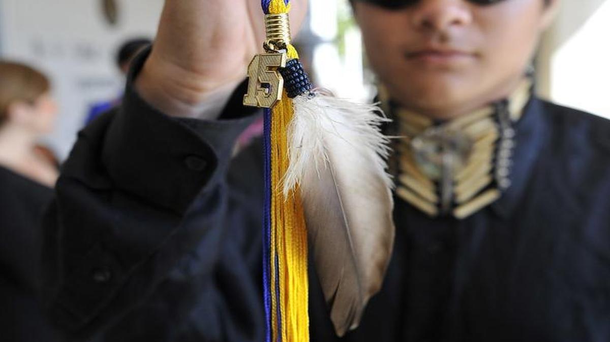 
Clovis High senior Christian Titman holds his graduation tassel with a hawk feather, after a hearing at the B.F. Sisk Courthouse. He wants to wear an eagle feather during graduation ceremonies. 
