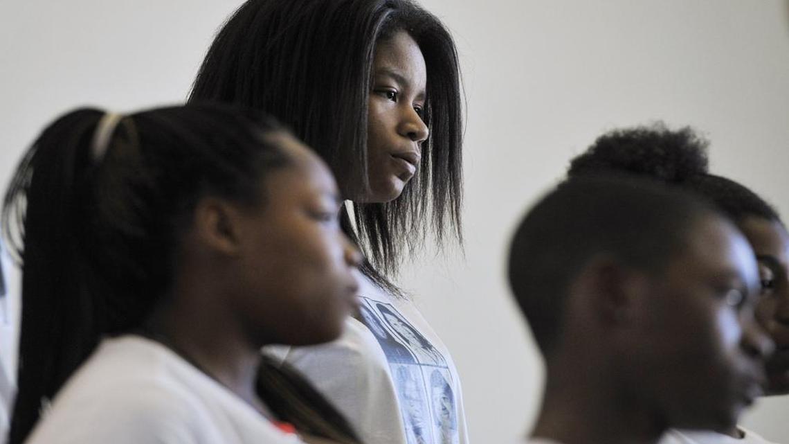 Gaston Middle School’s Brianna McGee, center, joins other members of the Gaston Middle School show choir as they hum “Amazing Grace” during a program kicking off Black History Month on Wednesday, Feb 3., 2016, in Fresno.