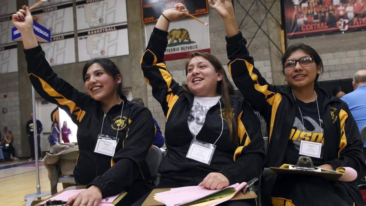 Martha Salazar, left, Azure Lopez, center, and Xitlali Pacheco from Edison High react after answering a question correctly during the second round of Fresno County’s Academic Decathlon Super Quiz held at Central High Saturday, Feb. 4, 2017 in Fresno, Calif.