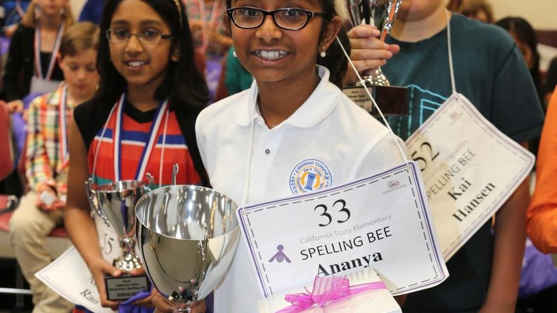 Ananya Vinay, center, with her championship trophy at the California State Elementary Spelling Bee in Stockton on Saturday, April 23, 2016. Ananya, a fifth-grader at Fugman Elementary School in Clovis, was the defending champion.
