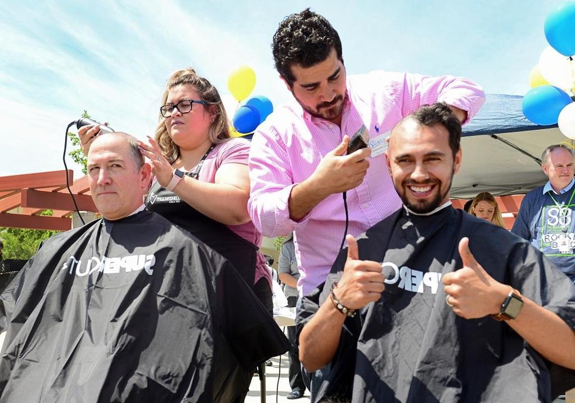 Sunnyside High School staff member Jesse Medina right, gives a thumbs-up while he and teacher Jon Bath have their heads shaved in support of a fundraiser for the St. Baldrick’s Foundation to raise money for kids with cancer, at Sunnyside High School on Thursday, April 27, 2017.