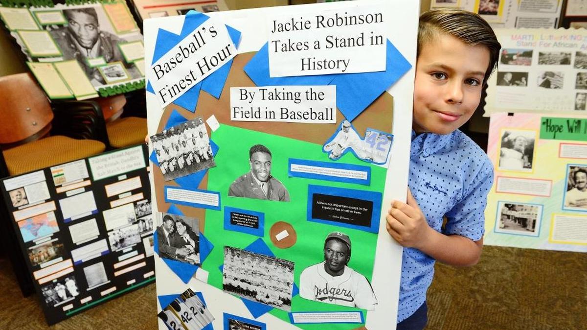 Diego Anderson, 9, a 4th grader from Cole Elementary in Clovis, holds up his history display on baseball legend Jackie Robinson during the 34th annual Fresno County History Day at Fresno Pacific University on Saturday, March 11. This year’s theme was “Taking a Stand in History” and included projects by more than 500 students.