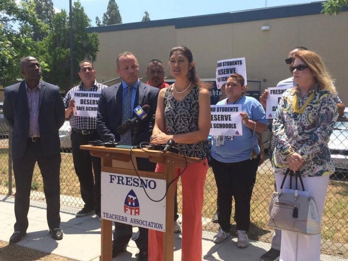 Fresno Teachers Association President Tish Rice stands alongside fellow teachers and Fresno Unified trustees in 2016 to call for better discipline policies. That is one of the issues being negotiated between district and FTA officials, with a strike vote looming.