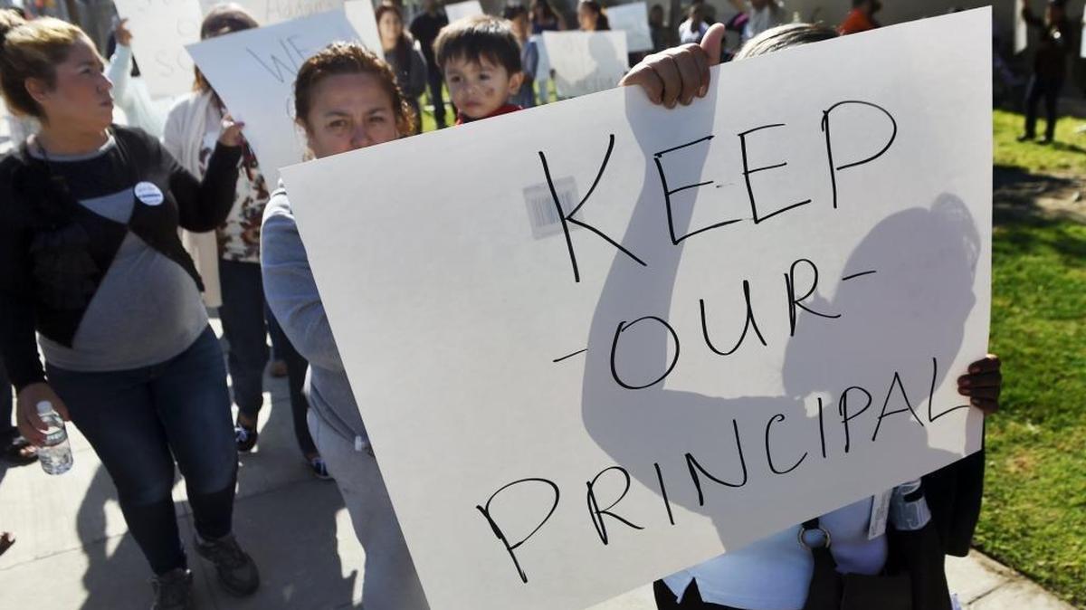 Dozens of supporters of current Addams Elementary Principal Sandra Toscano demonstrate against her reassignment by the school district outside the school on Wednesday, April 20, 2016, in Fresno.