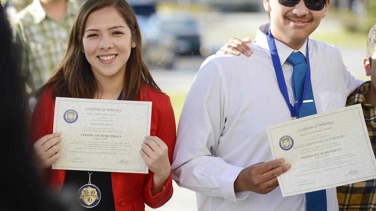 
Sunnyside High School seniors Giselle Meza and Manuel Buenrostro are photographed with family members after receiving honors for being proficient in more than one language during a senior awards banquet held at the school May 27. Fresno Unified graduated 425 students this year with seals of biliteracy.
