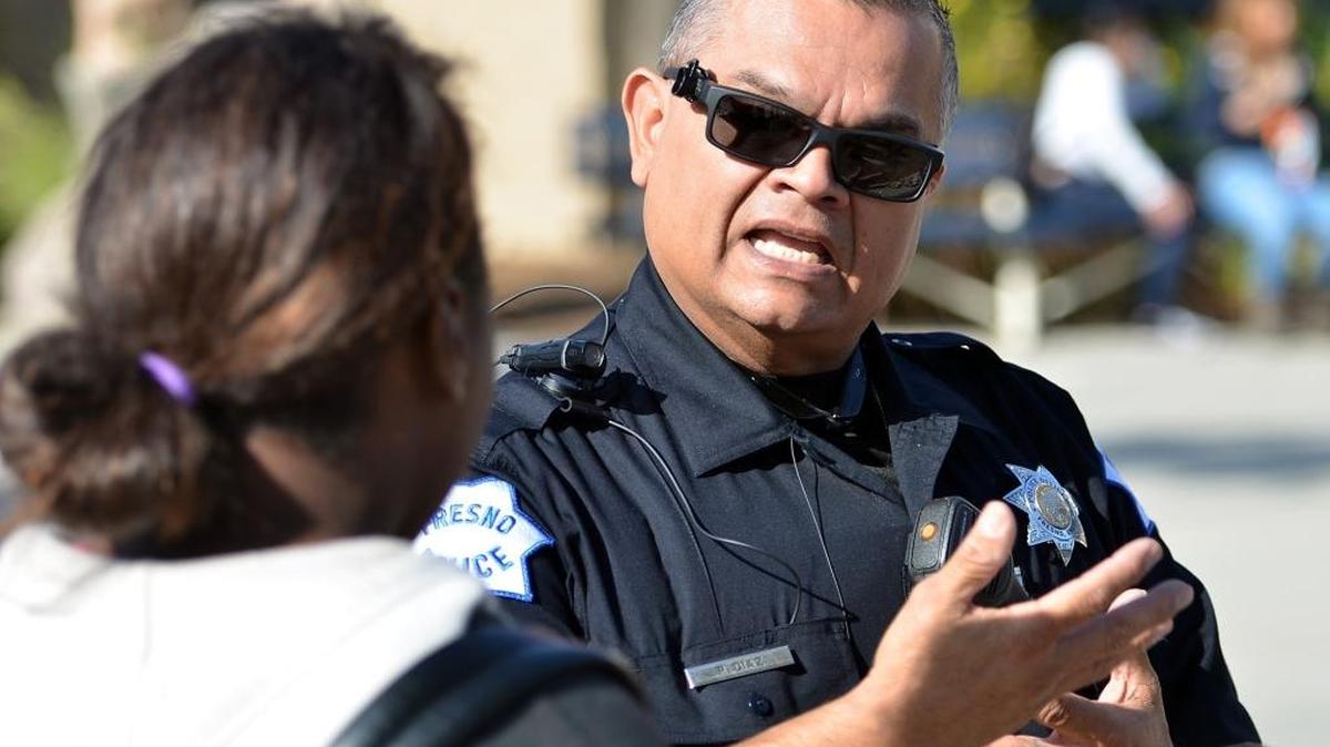 Student Resource Officer Roland Diaz speaks with a student during lunch at Sunnyside High School in Fresno.