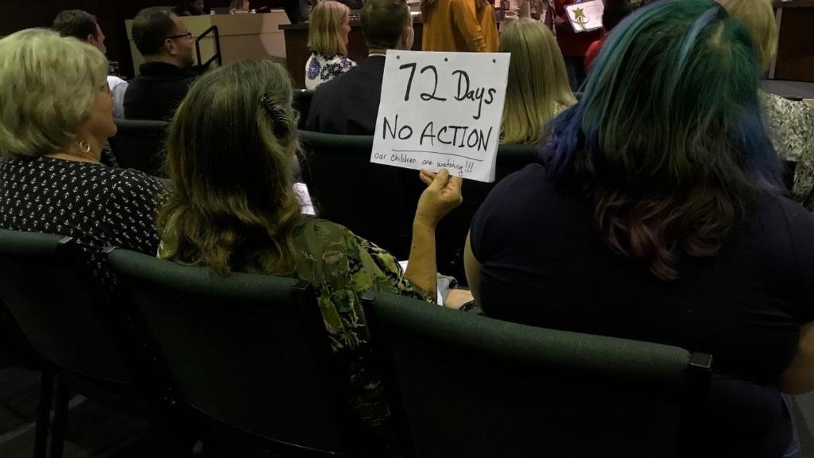 Bernadette Planting holds a sign at a Fresno Unified school board meeting Wednesday, Nov. 8, 2017, noting how long it’s been since the board was officially asked to demote Brooke Ashjian from his role as president after his anti-LGBT comments. “Our children are watching,” the sign reads.