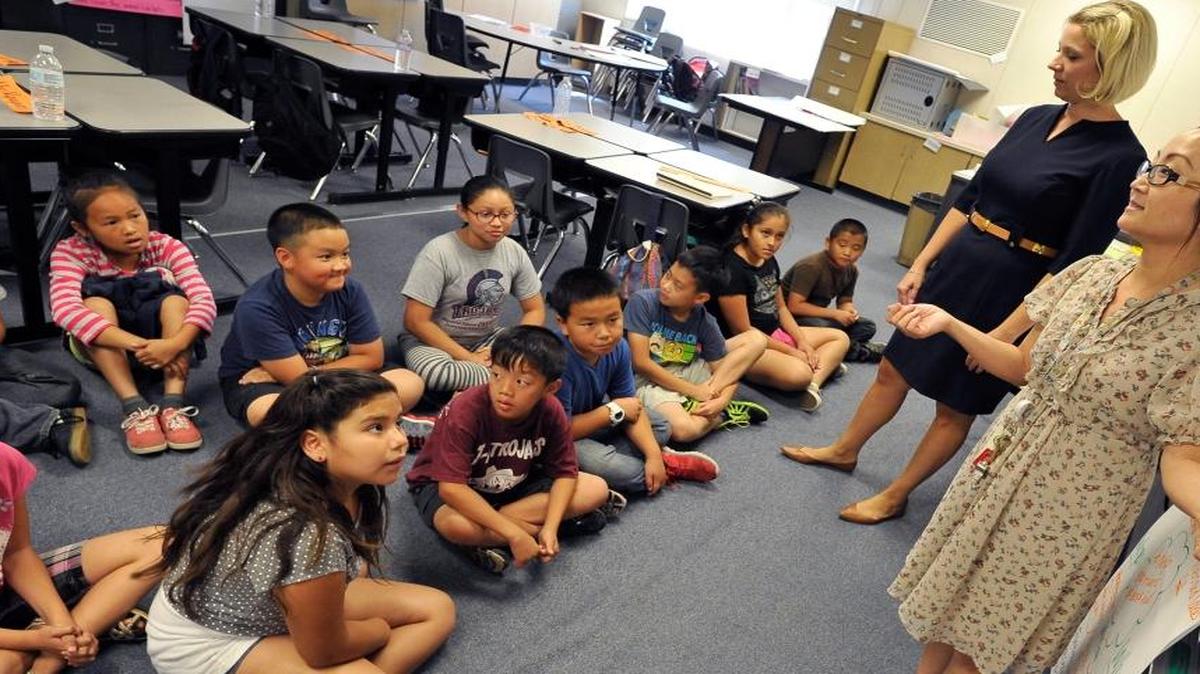Teacher Yer Vang, right, assisted by Heidi Rochin, education consultant, goes over a lesson with her 4th and 5th graders at Clovis Unified’s Miramonte Elementary School.