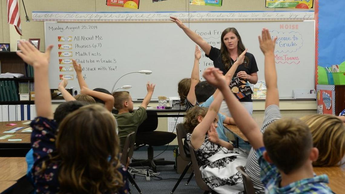 Third-grade teacher Chelsea Toews asks for a show of hands at Liberty Elementary School in Clovis Unified on the first day of class in 2014. Such scenes are about to be renewed in schools throughout Fresno County.