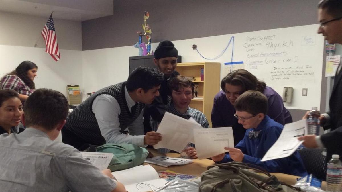 Members of the Design Science Academic Decathlon team look over paperwork during a night of practicing for the first day of the Fresno County Academic Decathlon, which will be held Saturday. Design Science will compete in Division III of the competition for their first time this year, after winning in Division IV at last year’s regional competition.