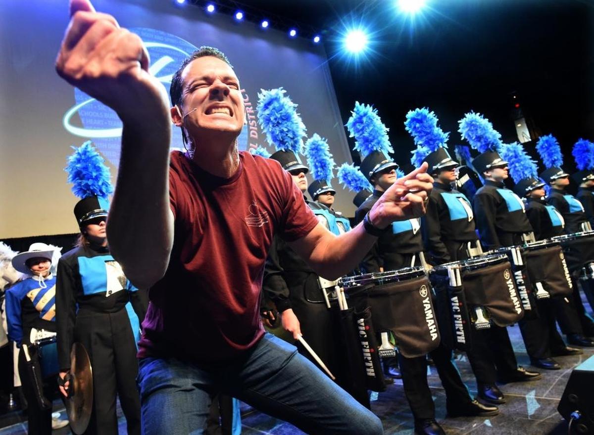 Kevin Miller, Clovis North transitional coordinator, gets the crowd engaged in a participatory drum beat before the Clovis North band drum line performs during the Clovis Unified Back to School Rally at the Save Mart Center Tuesday to celebrate together the start of the 2017-18 school year.