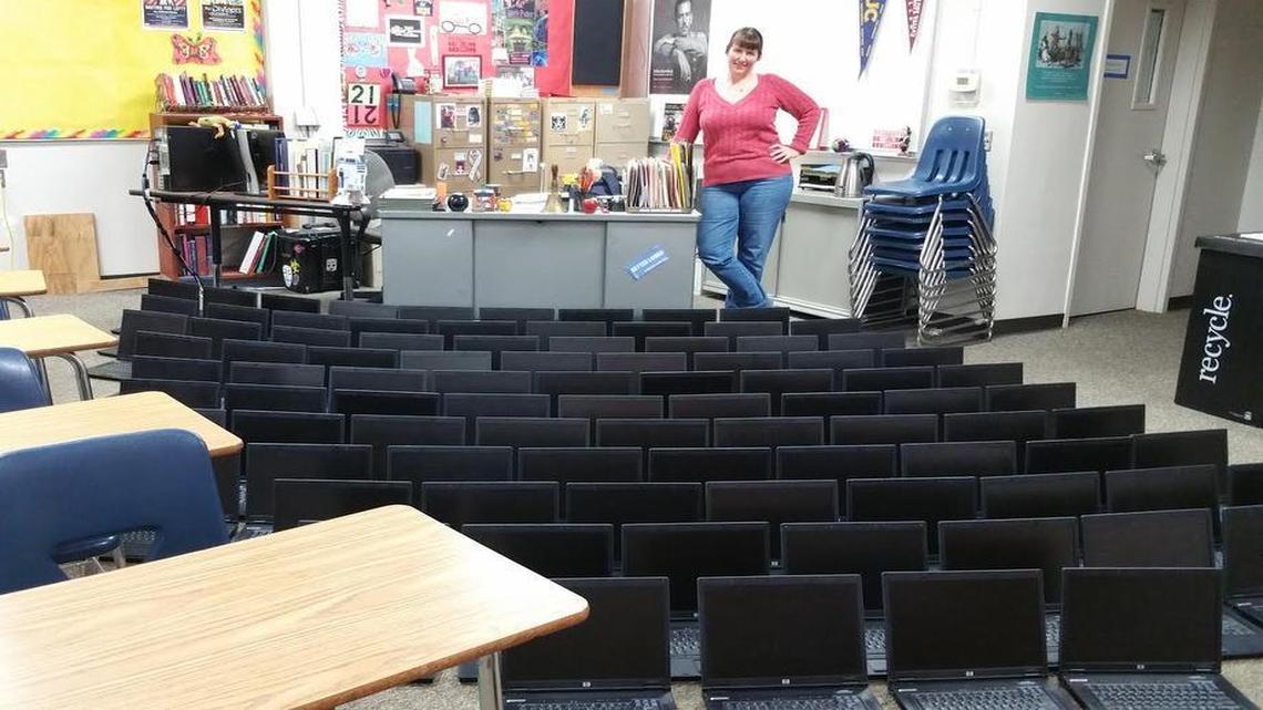 Teacher Kim Kutzner poses with the dozens of laptops she donated to students at Chowchilla Union High School. District officials are questioning whether the computers are allowed in the classroom.