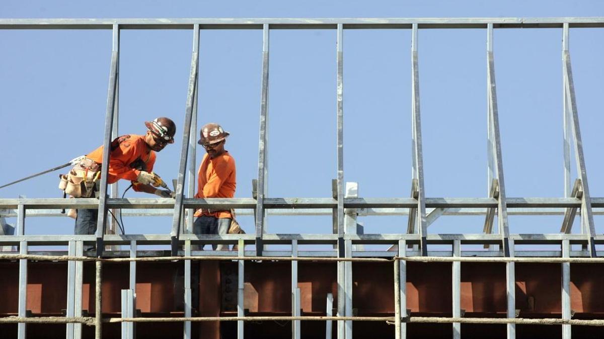 Harris Construction employees work on the roof of Fresno High School in 2012. The firm came under scrutiny over a contract given to it for construction of Gaston Middle School.