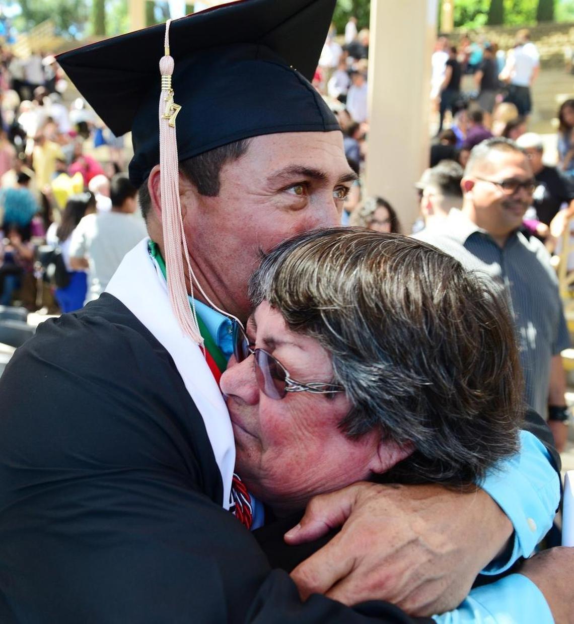 Arnold Trevino, one of four graduates in Fresno State’s Project Rebound, hugs his mother, Guadalupe Trevino of Porterville, following the Department of Social Work Education graduation ceremony at Woodward Park’s Rotary Amphitheater on Friday, May 19, 2017.