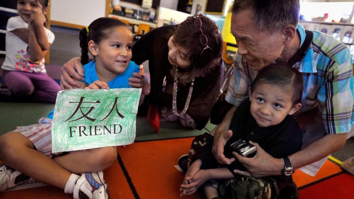 
Anabel Lujan, 4, left, shows her “friend” creation to Shoko Tominaga, center, and husband Kuniaki, right, with Orian Gomez, 4. A sister-city delegation from Kochi, Japan, dropped in on Holland Elementary School’s transitional kindergarten class Wednesday morning. A sister-city delegation from Kochi first visited Holland Elementary in 1965.
