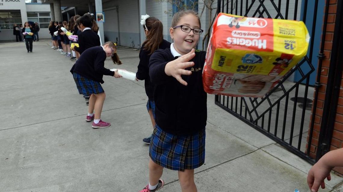 St. Anthony’s School fourth-grader Elaina Khoury, 10, helps load 15,276 donated diapers for the Saint Agnes Holy Cross Center for Women into a van on Friday, March 24, 2017, at the school in northwest Fresno. Saint Agnes Holy Cross Center for Women benefits homeless and underserved women and their children. See a video report on the diaper drive, www.fresnobee.com/education