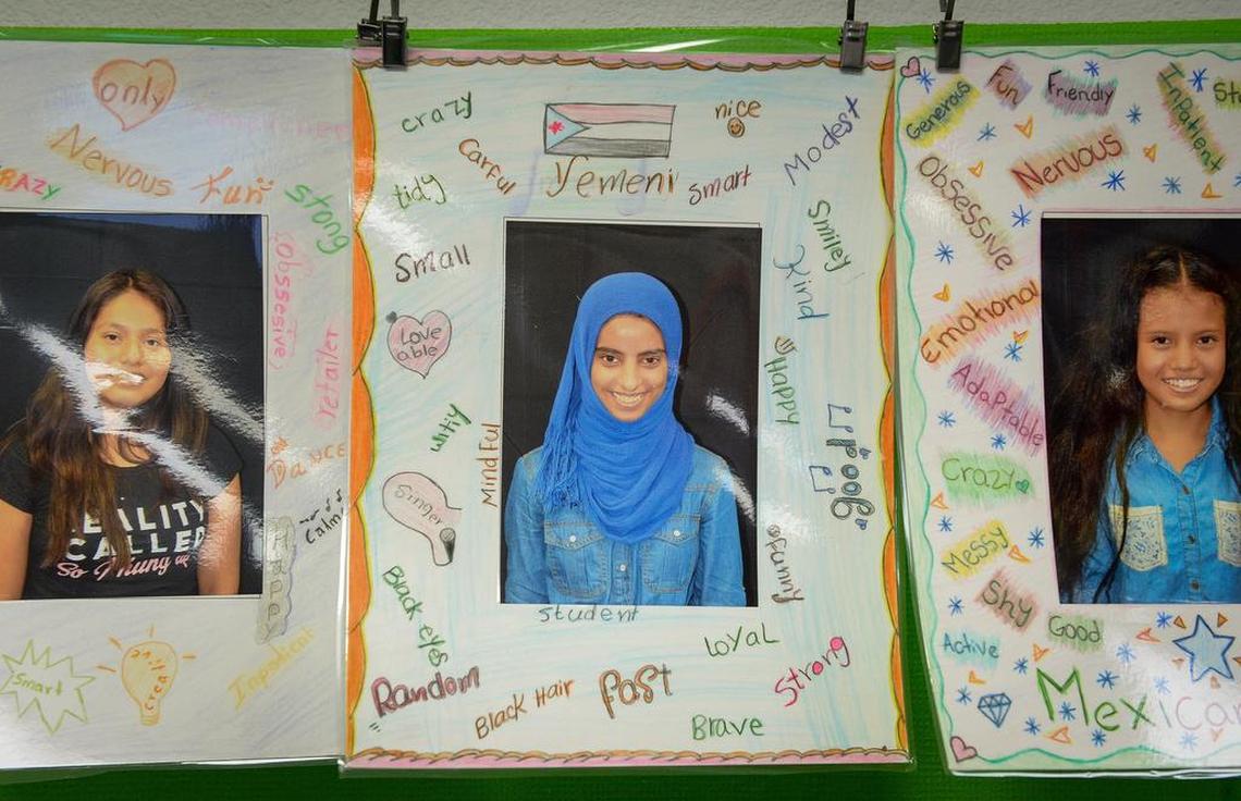 A photo of newcomer student Amal Qasem, 15, placed among English words she uses to describe herself, hangs among other students photos in Efraín Tovar’s class at Abraham Lincoln Middle School in Selma on Friday, Jan. 11, 2019.
