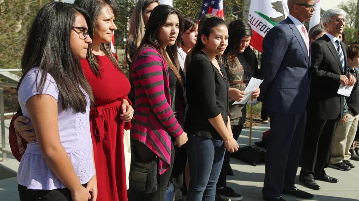 Attorneys Theodore Boutrous, far right, and Marcellus McRae, second from right , take questions from the media, as they are joined by nine California public school students who are suing the state to abolish its laws on teacher tenure, seniority and other protections, during a news conference outside the Los Angeles Superior court in January 2014.// Their case Vergara v. California is the latest battle in a growing nationwide challenge to union-backed protections for teachers.