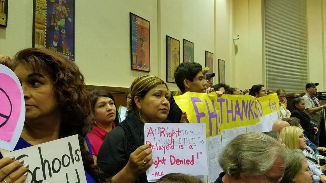 Students and parents hold signs on Wednesday, March 8, 2017, in support of a resolution making Fresno Unified schools safe havens for undocumented students. The Fresno Unified board voted unanimously to pass the resolution.