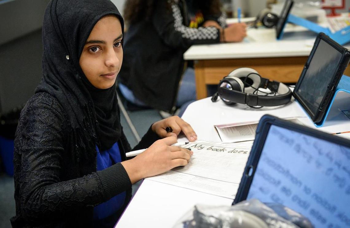 Amal Qasem, 15, an eighth-grader in Efraín Tovar’s newcomers class, works on an English lesson during class at Abraham Lincoln Middle School in Selma on Friday, Jan. 11, 2019.