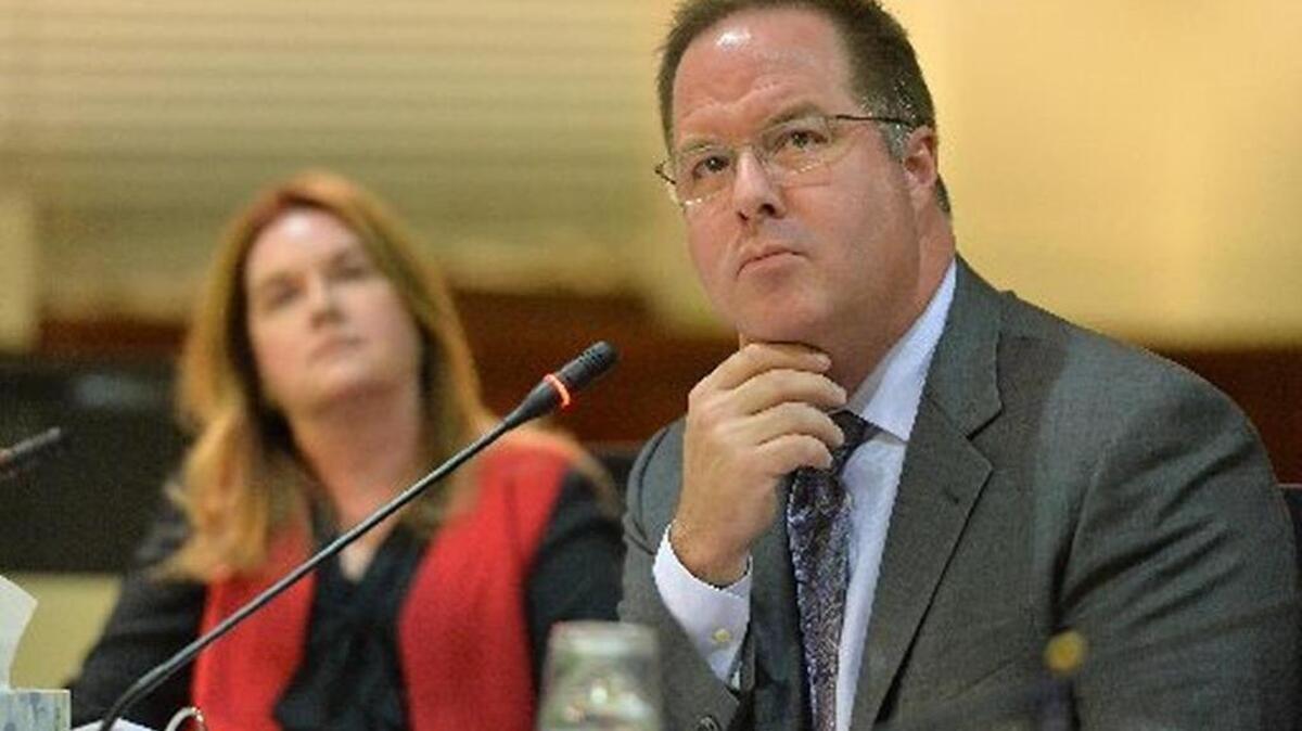 Fresno Unified School District Superintendent Michael Hanson and Trustee Carol Mills, during a school board meeting Dec. 14. Hanson will step down next summer.