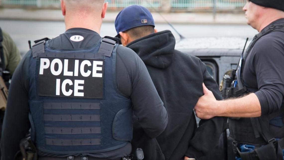U.S. Immigration and Customs Enforcement agents arrest an undocumented man in Los Angeles in February. A recent arrest of an undocumented father in Visalia when he picked up his daughter from school has been criticized by area school board members and immigration lawyers.