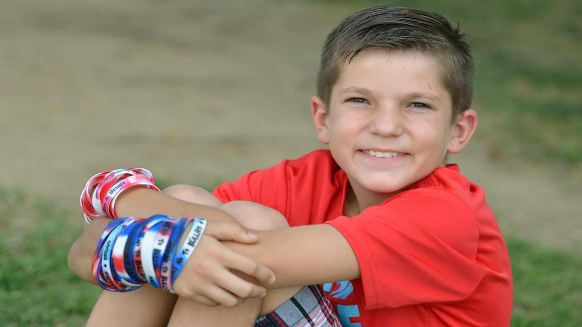
Ryan Warren, 10, shows off his anti-bullying campaign bracelets at Hallmark Charter School in Sanger. Warren started an anti-bullying campaign that is leading to him being recognized by the Sanger City Council on Thursday.
