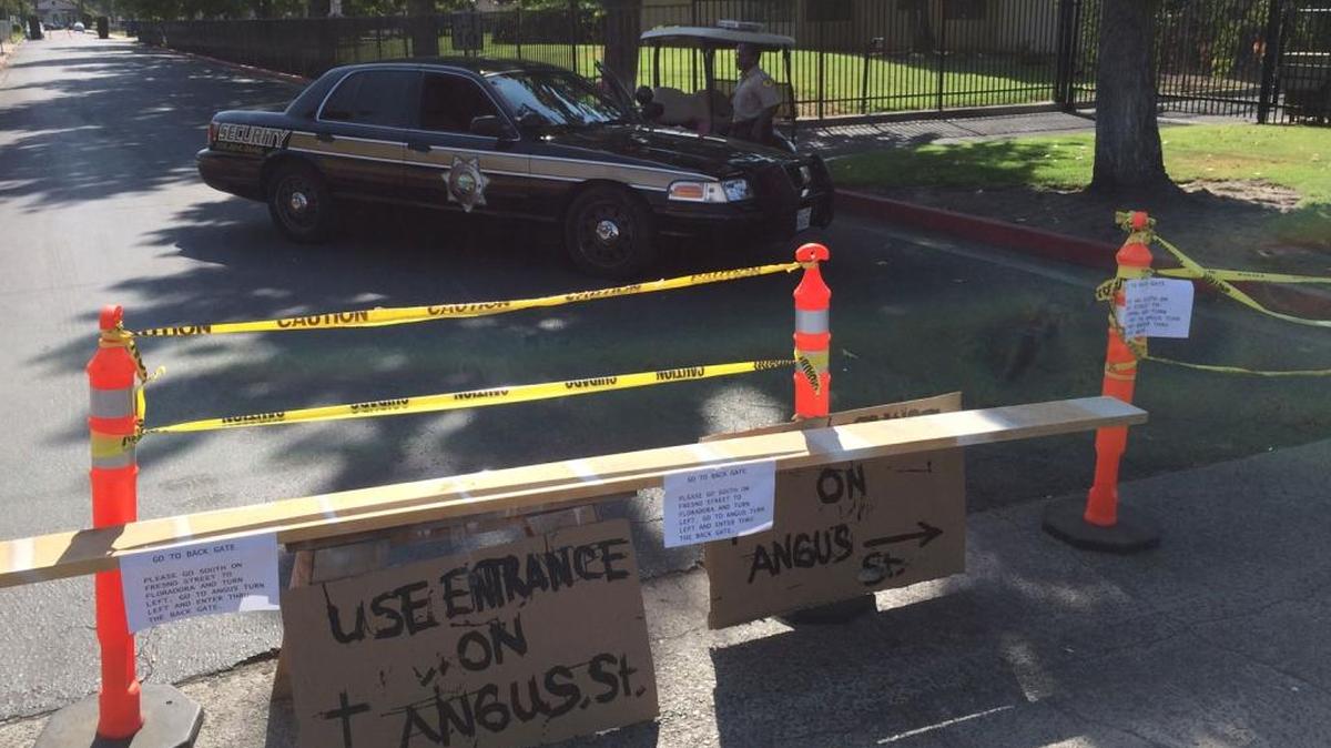 
Security officers monitor one of the closed entrances to San Joaquin Memorial High School on Tuesday, Sept. 1, 2015. School officials canceled the day’s classes after learning of an Instagram post by a student that contained violent language
