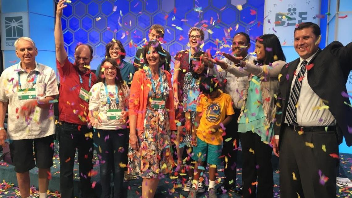 Paul Loeffler, far right, celebrates with Ananya Vinay, who is at center behind her brother in the yellow shirt, after she won the 2017 Scripps National Spelling Bee. Ananya’s parents are next to her, and other friends join in.