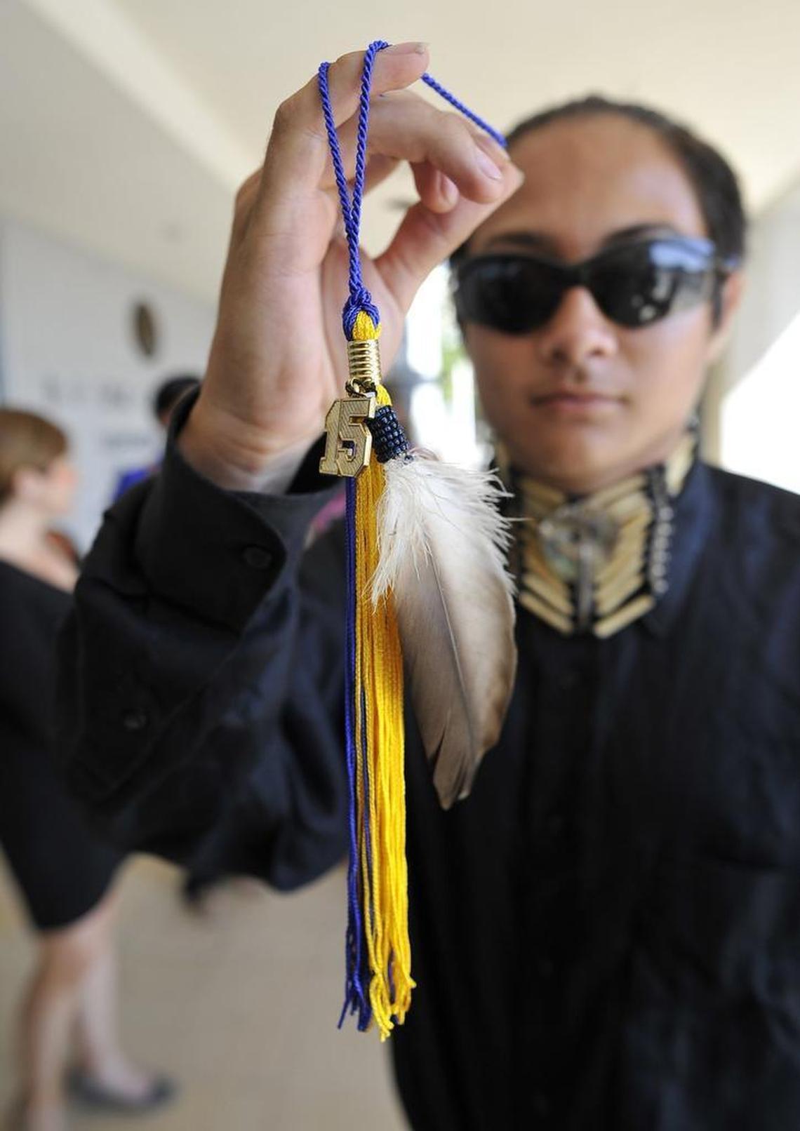 Clovis High senior Christian Titman holds his graduation tassel with a hawk feather, after a hearing at the B.F. Sisk Courthouse. He wants to wear an eagle feather during graduation ceremonies.