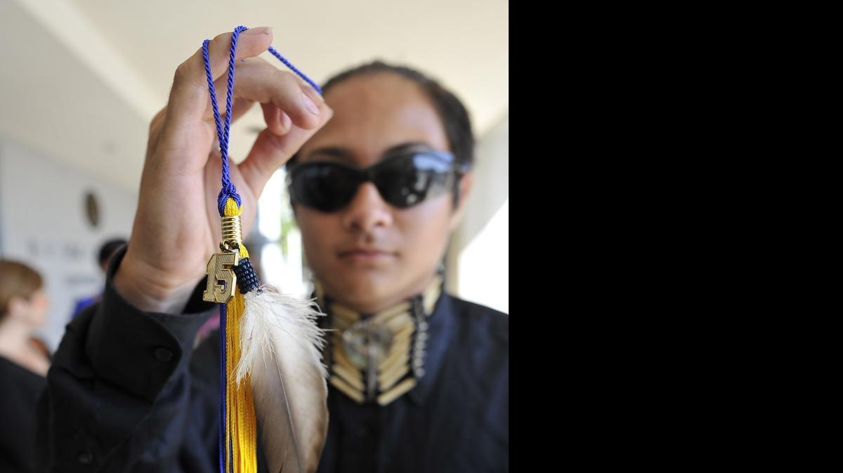 
Clovis High senior Christian Titman holds his graduation tassel with a hawk feather, after a hearing at the B.F. Sisk Courthouse. He wants to wear an eagle feather during graduation ceremonies. 

