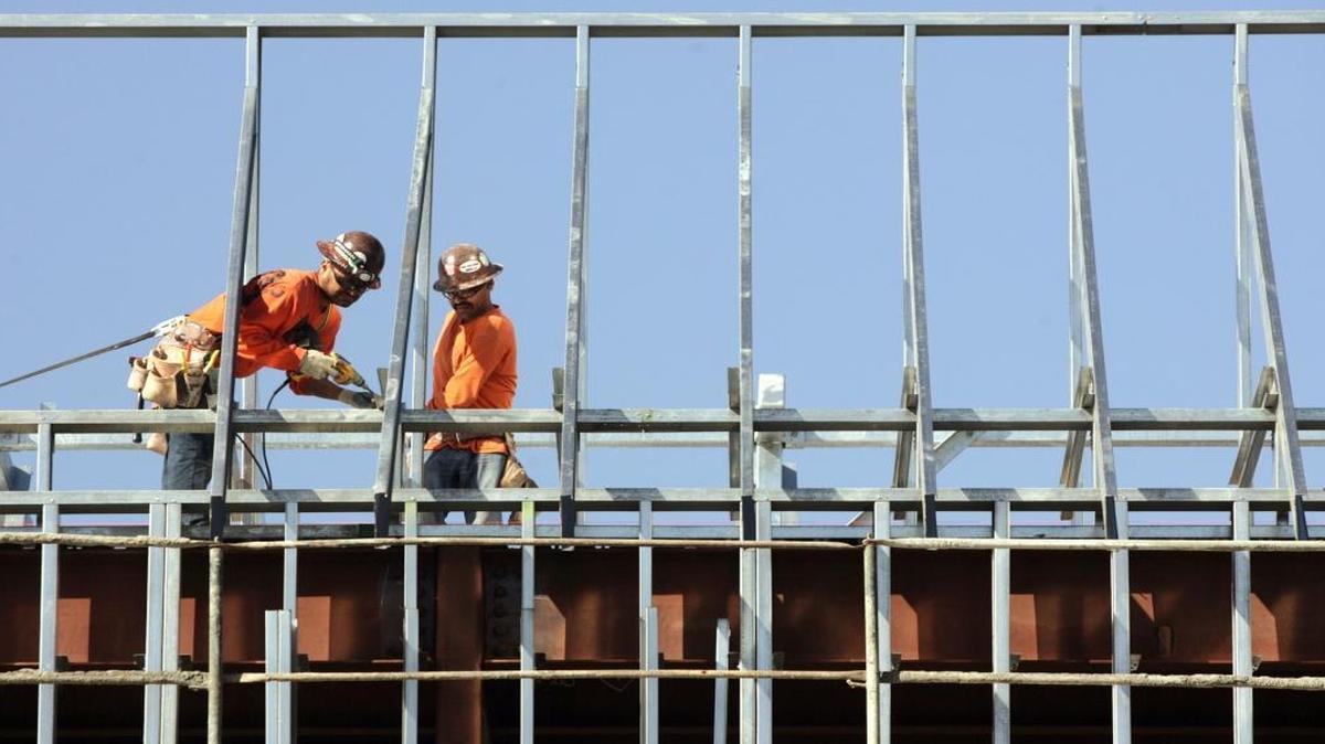 Harris Construction workers put beams into place on the roof of one of two classroom buildings being built at Fresno High School in a 2012 project.