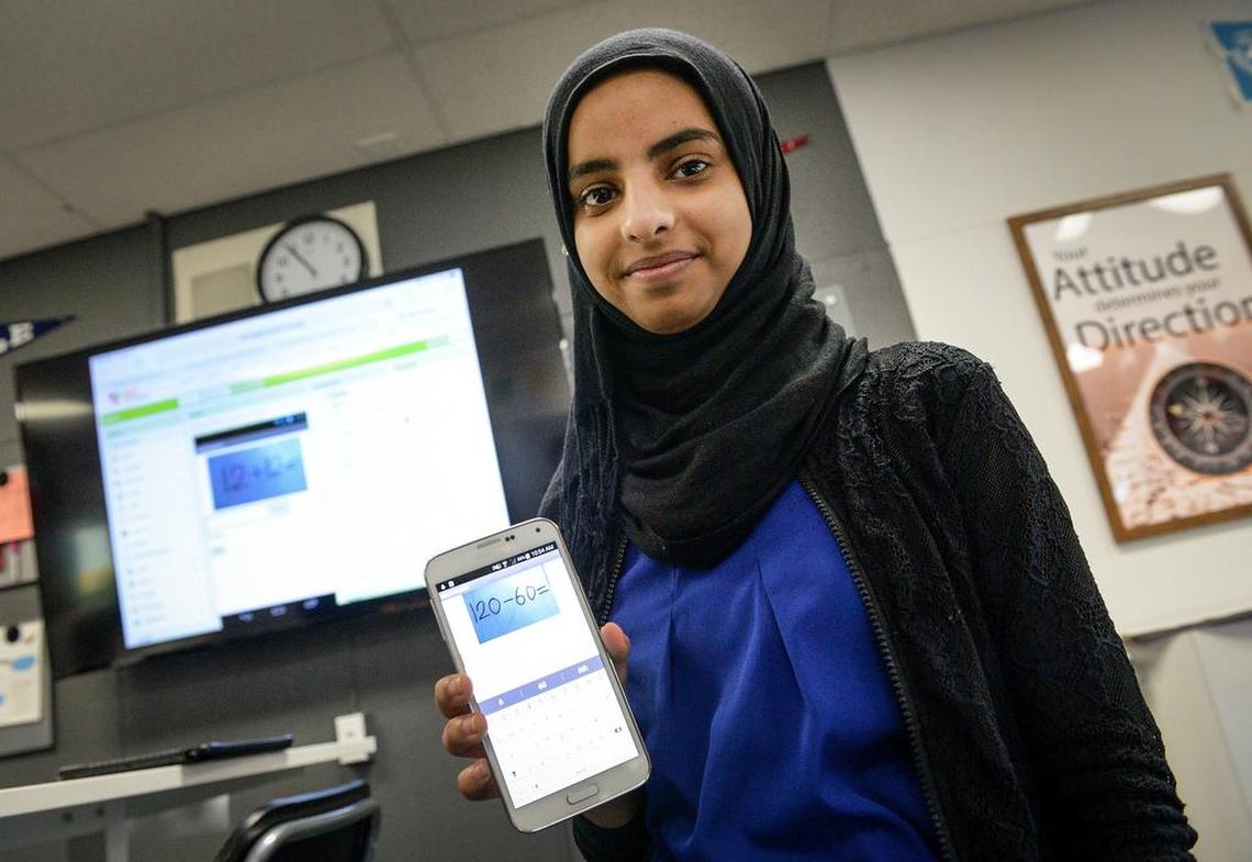 Amal Qasem, 15, an eighth-grader in Efraín Tovar’s newcomers class, holds up a smart phone showing a math app she created at Abraham Lincoln Middle School in Selma on Friday, Jan. 11, 2019.