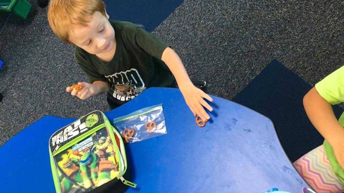 Jack Plow, age 4, shares his pretzels with a classmate in Laura Smith’s transitional kindergarten classroom at Lakewood Elementary School in Sunnyvale, Calif.