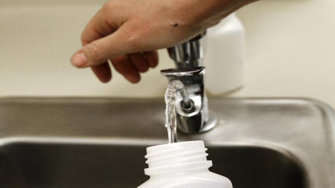 In this 2016 file photo, a sample of drinking water is taken from a fountain at a Tacoma, Wash., public school. The city of Fresno had been conducting tests on Fresno Unified drinking fountains as part of a new state law mandating lead testing on all school campuses.