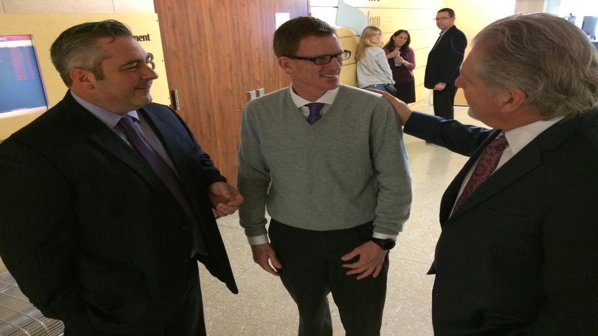 Dr. Michael J. Moffett, center, chats with his lawyers, Travis Stokes, left, and Charles Doerksen, right, after spending the day on the witness stand Jan. 28 in Fresno County Superior Court. He has sued California Cancer Associates for Research and Excellence, widely known as cCare, for breach of his employment contract. cCare has counter-sued the doctor for financial misconduct. The dark-haired woman in the background is Marie E. Shaffer, Moffett’s administrative assistant and fiancé. Former colleagues contend they committed financial misconduct.