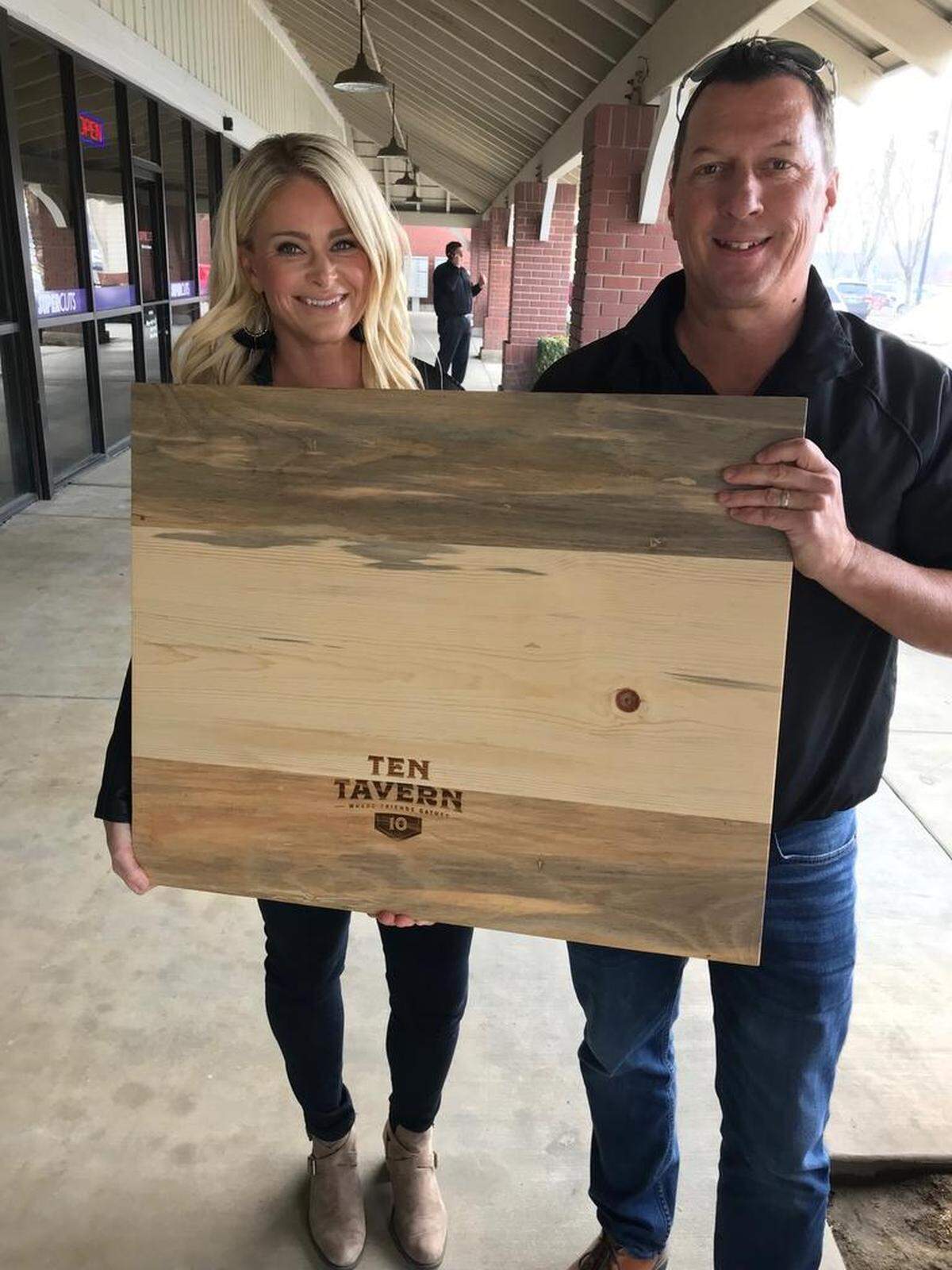 Amy and Matt Sherrell, part owners of Ten Tavern in Clovis, show off the table tops of their new restaurant.