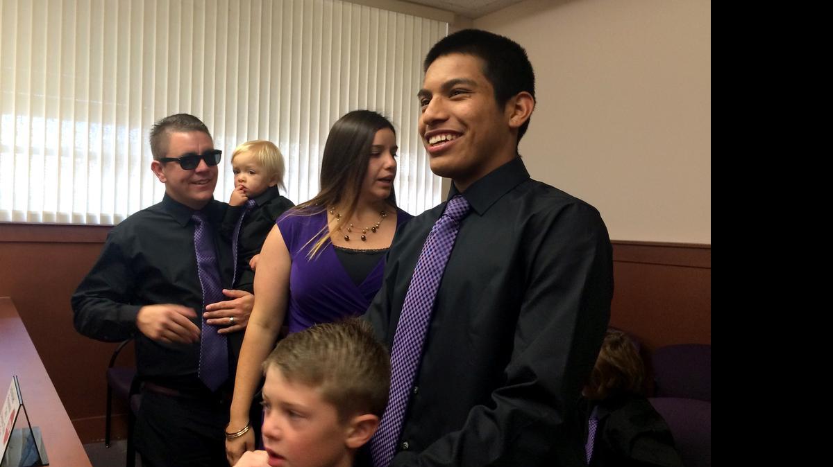 
Cruz Holiman rests his hands on the shoulders of his little brother Nathan after filing into the Modesto courtroom where the hearing for his adoption finalization was held May 4. 
