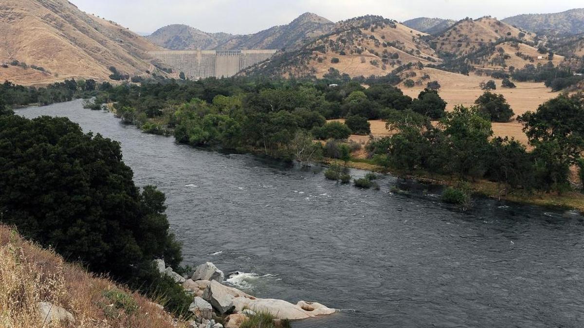 The swollen Kings River flows downstream of Pine Flat Dam, background, Wednesday afternoon, May 24, 2017 near Piedra, Calif.